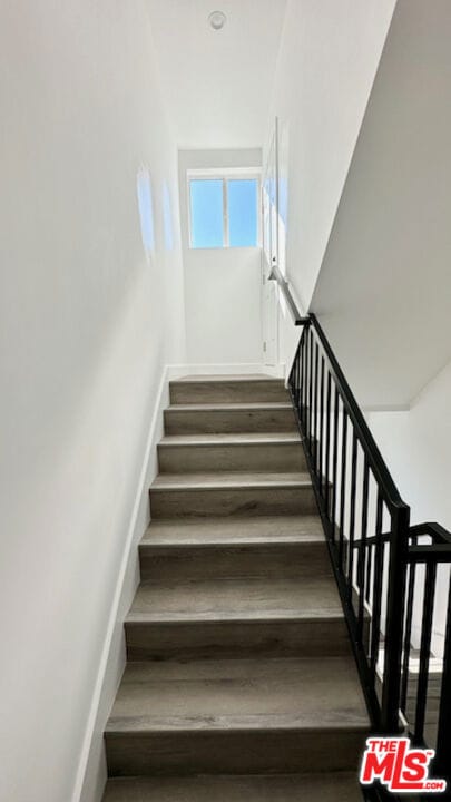 stairway featuring hardwood / wood-style floors