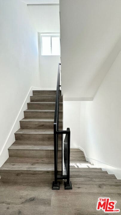 stairs featuring hardwood / wood-style flooring