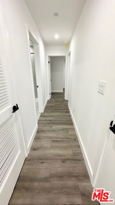 hallway featuring dark wood-type flooring