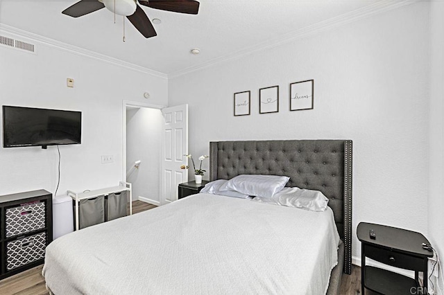 bedroom with hardwood / wood-style flooring, ceiling fan, and crown molding