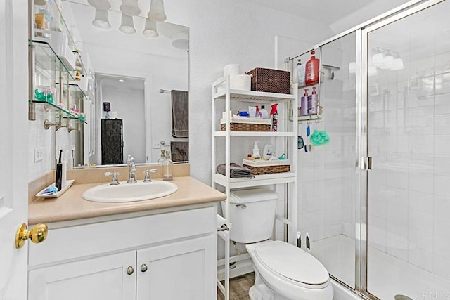 bathroom with vanity, toilet, and an enclosed shower