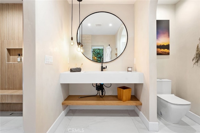 bathroom featuring sink and toilet