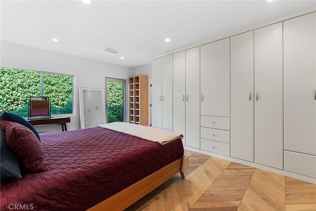 bedroom with light parquet flooring