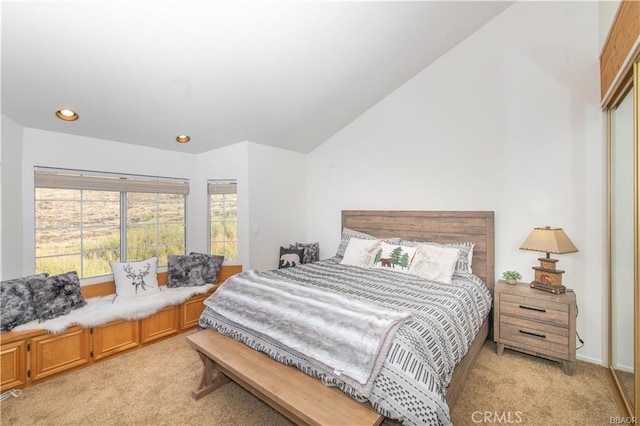 carpeted bedroom with lofted ceiling