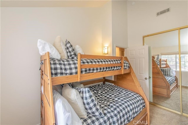 bedroom with light carpet and a closet