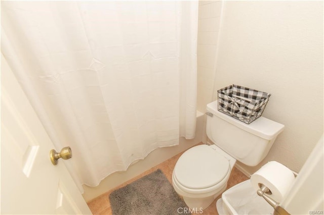 bathroom with toilet and shower / bath combo