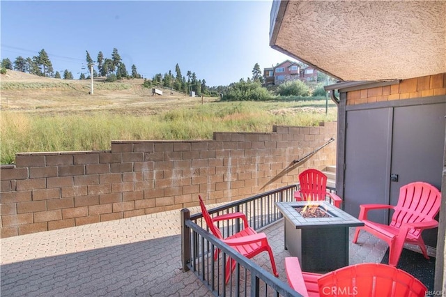 view of patio with a fire pit