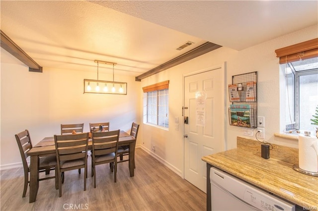 dining area featuring a healthy amount of sunlight and light hardwood / wood-style flooring