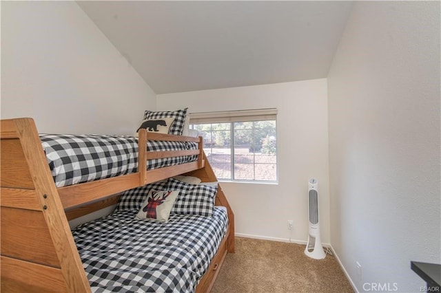 carpeted bedroom featuring lofted ceiling