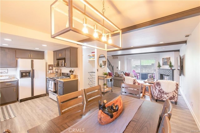 dining space with light wood-type flooring