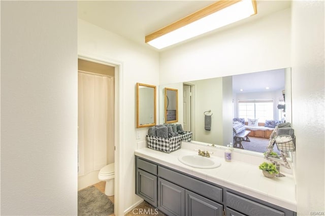 bathroom featuring vanity and toilet