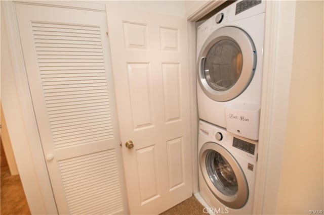 laundry area with stacked washer / drying machine