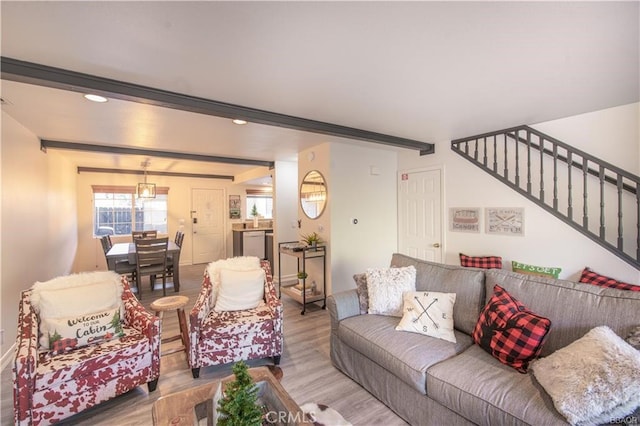 living room featuring beamed ceiling and hardwood / wood-style flooring