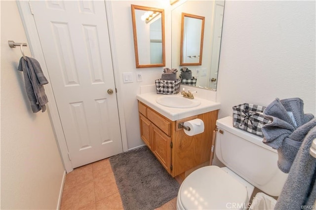 bathroom with tile patterned floors, toilet, and vanity