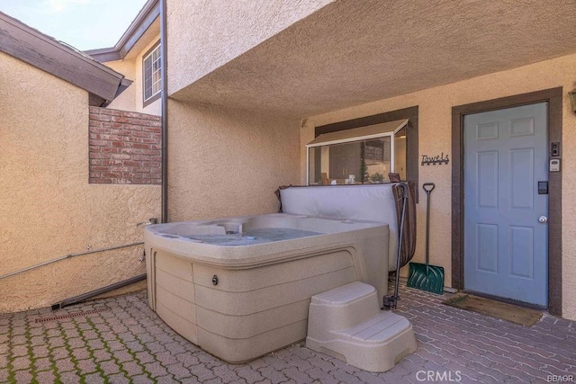 view of patio / terrace featuring a hot tub