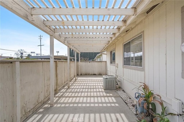 view of patio featuring central AC and fence