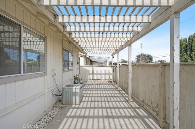 view of patio / terrace with fence, a pergola, and cooling unit