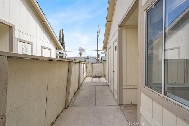 view of side of property featuring a patio and fence