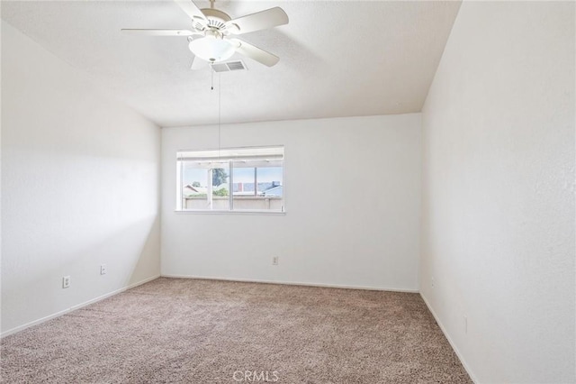 empty room with ceiling fan, carpet floors, and visible vents