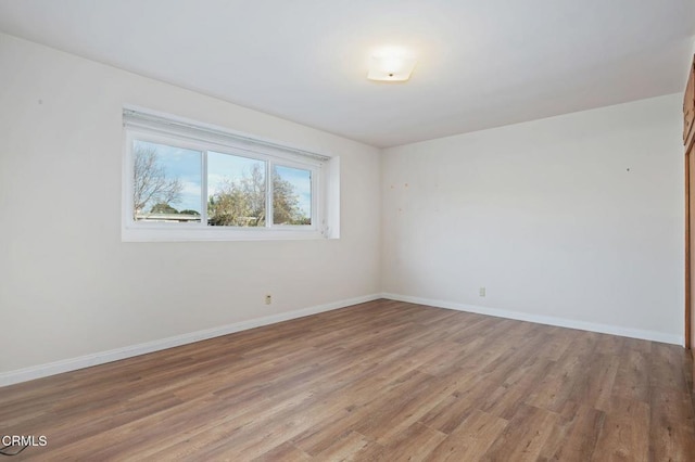 spare room with light hardwood / wood-style flooring