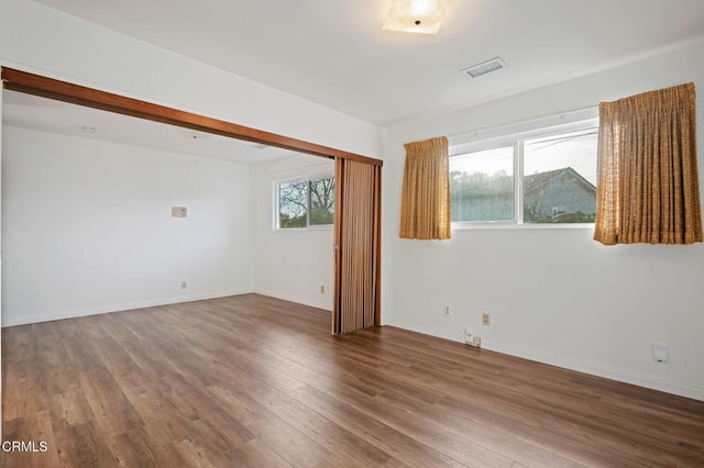 empty room with hardwood / wood-style floors