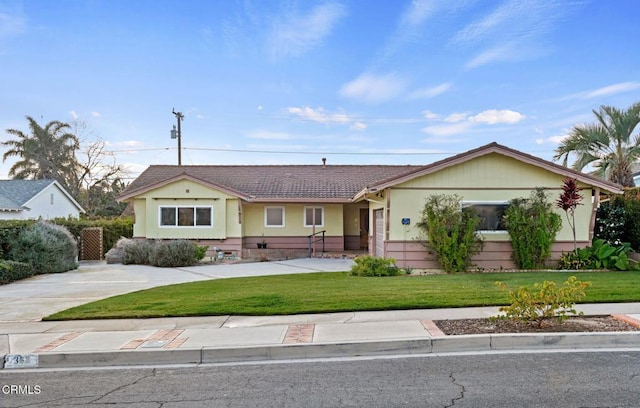 ranch-style home featuring a front yard