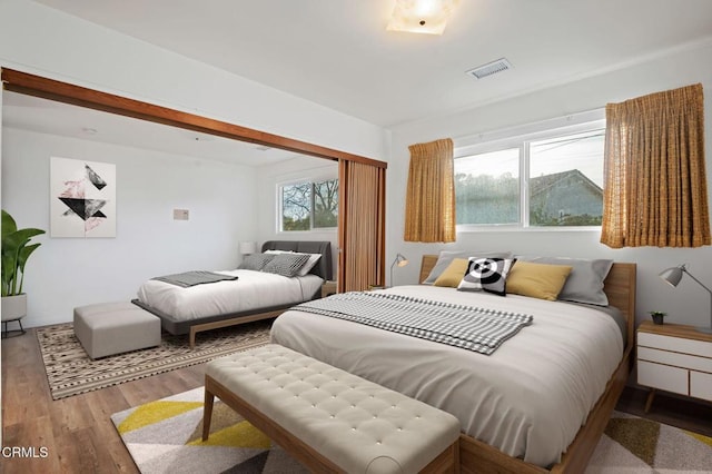 bedroom with hardwood / wood-style floors