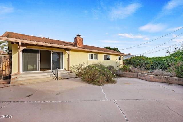 back of property with a patio area