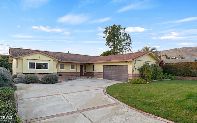 single story home featuring a garage and a front yard