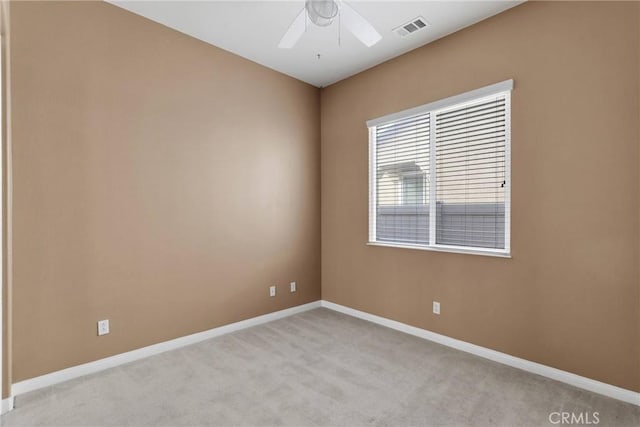 carpeted spare room featuring ceiling fan