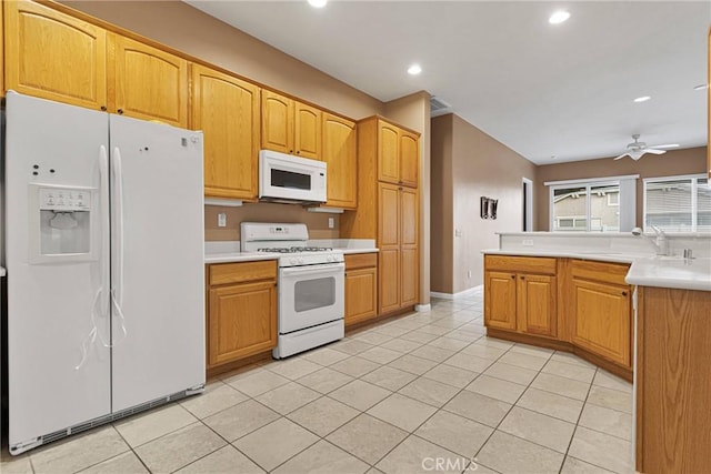 kitchen featuring ceiling fan, sink, light tile patterned floors, and white appliances