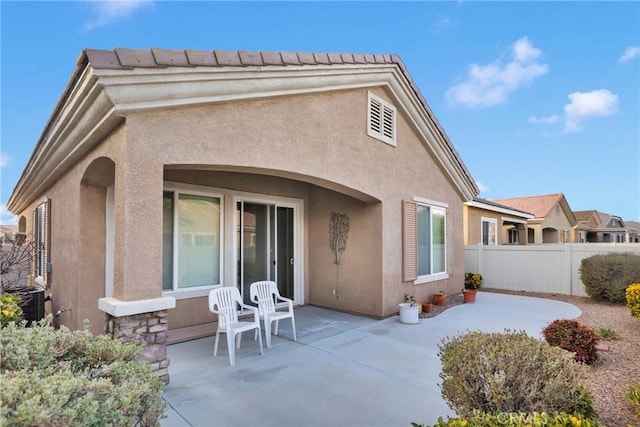 rear view of property with a patio and cooling unit