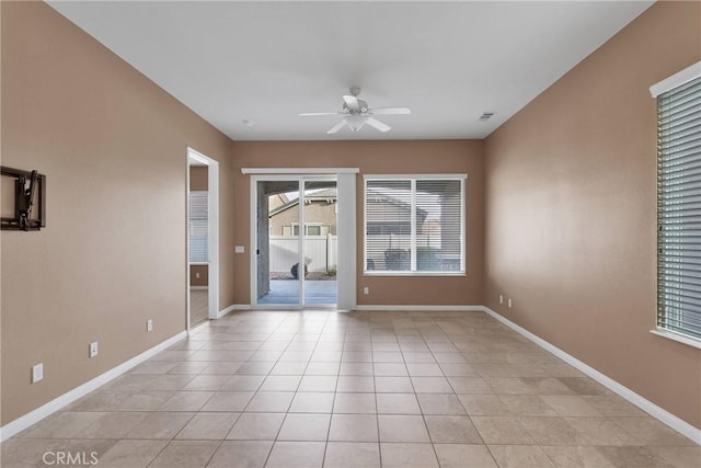 unfurnished room with light tile patterned floors and ceiling fan