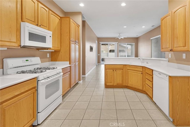 kitchen with light tile patterned flooring, sink, ceiling fan, kitchen peninsula, and white appliances