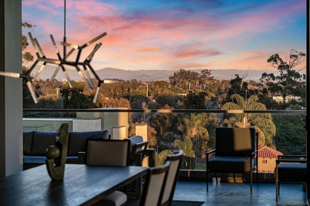 patio terrace at dusk featuring a balcony and a mountain view