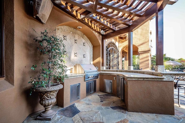 view of patio / terrace featuring area for grilling and a pergola