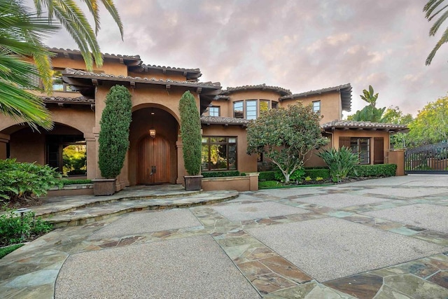 mediterranean / spanish house featuring a patio area