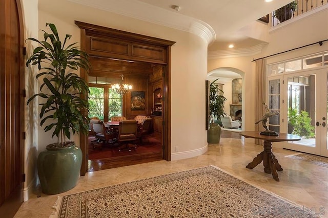 interior space featuring ornamental molding, an inviting chandelier, and french doors