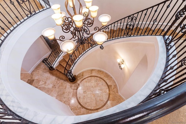 stairway featuring a chandelier