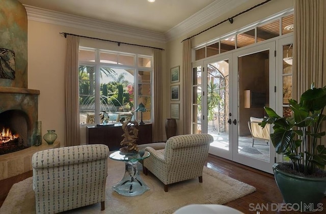 sitting room featuring crown molding, wood-type flooring, and french doors