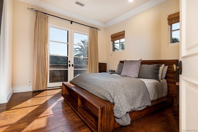 bedroom with ornamental molding, access to exterior, dark hardwood / wood-style flooring, and french doors