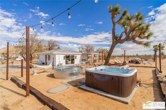 exterior space with an outbuilding and a hot tub