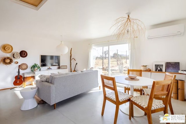 dining area with a wall mounted air conditioner and concrete floors