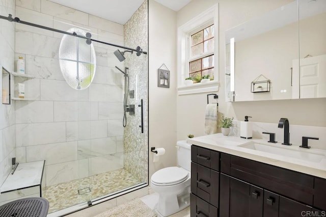 bathroom featuring vanity, toilet, and an enclosed shower