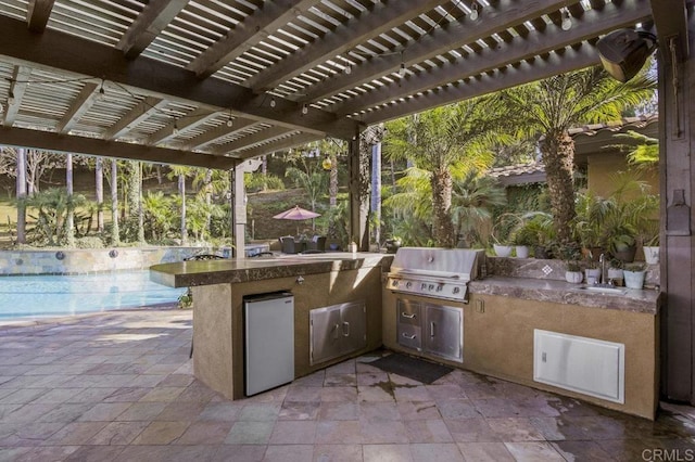 view of patio featuring an outdoor kitchen, a grill, a pergola, and sink