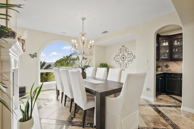 dining space featuring a notable chandelier