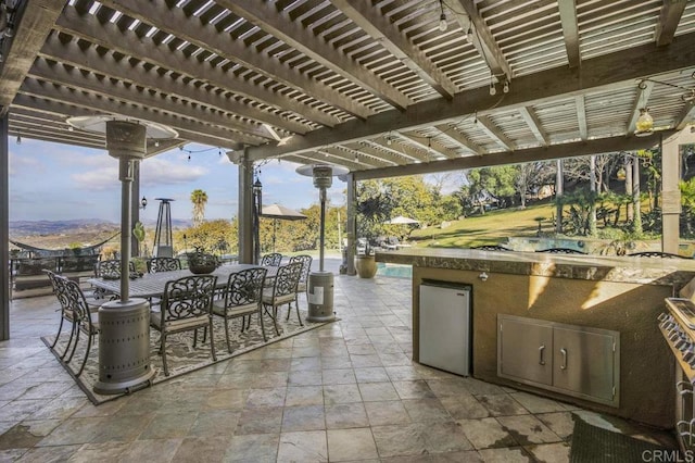 view of patio featuring a mountain view and a pergola