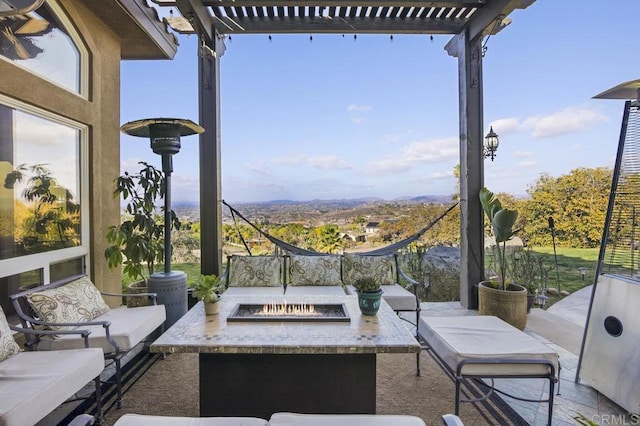 view of patio with an outdoor living space with a fire pit and a pergola