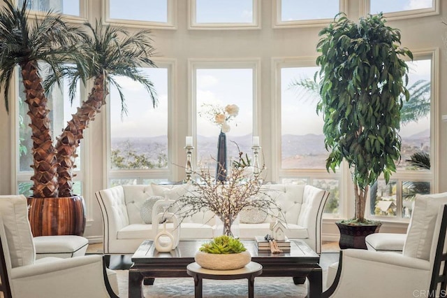 sunroom / solarium featuring a mountain view and plenty of natural light