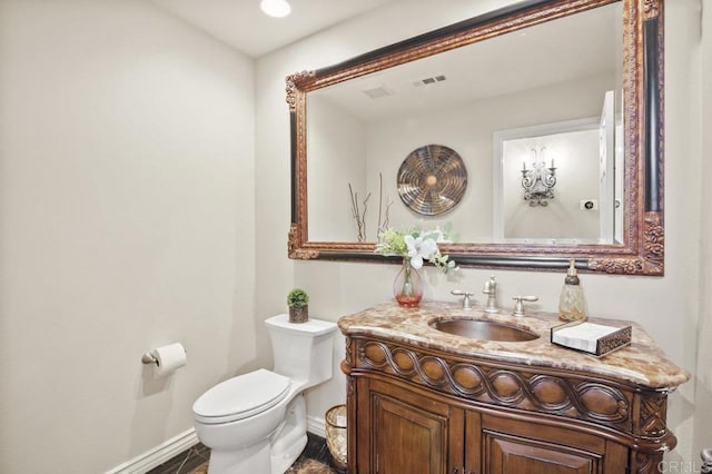 bathroom featuring vanity and toilet